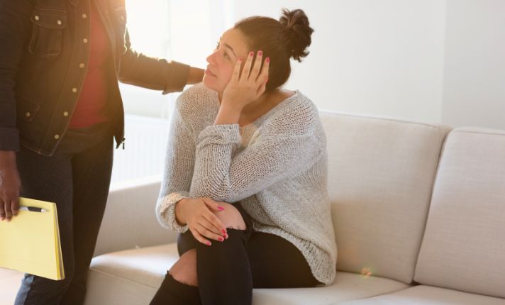 A woman with access to mental health services in rural areas is talking to a therapist.