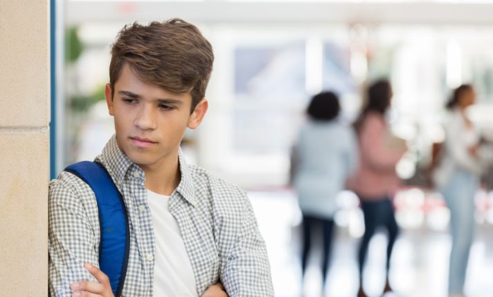A boy who needs suicide prevention in Utah is at school looking sad.
